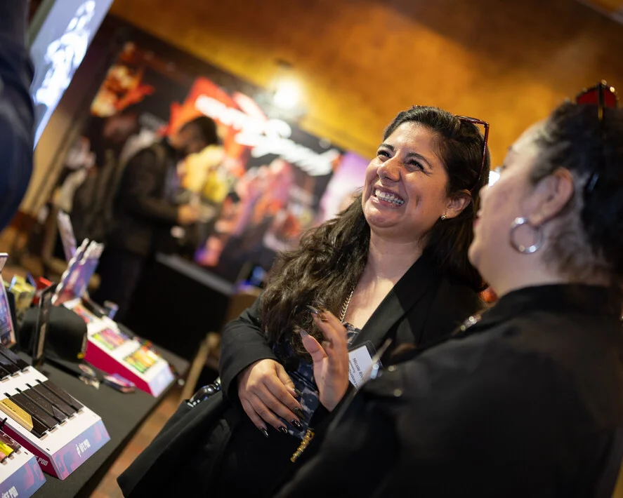 Smiling visitors at the Life Pod stand